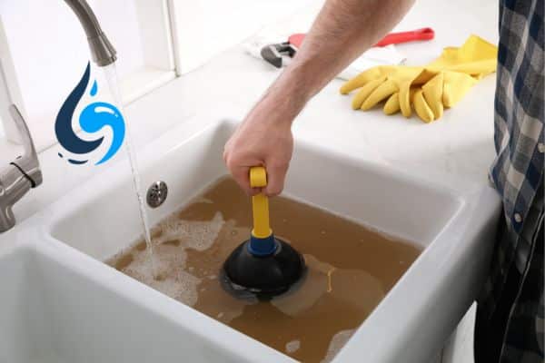 plumber fixing a clogged drain houston tx